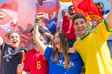 Diverse soccer fans cheering and celebrating with flags © william87