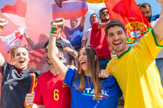 Diverse soccer fans cheering and celebrating with flags