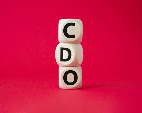 CDO - Collateralized Debt Obligation symbol. Wooden cubes with word CDO. Beautiful red background. Business and Collateralized Debt Obligation concept. Copy space.