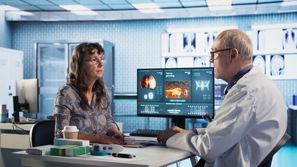 Fototapeta na wymiar Male doctor professional uses oximeter to measure the oxygen levels for woman at checkup visit, accurate medical advice for recovery. Monitoring pulse and saturation with tool. Camera A.