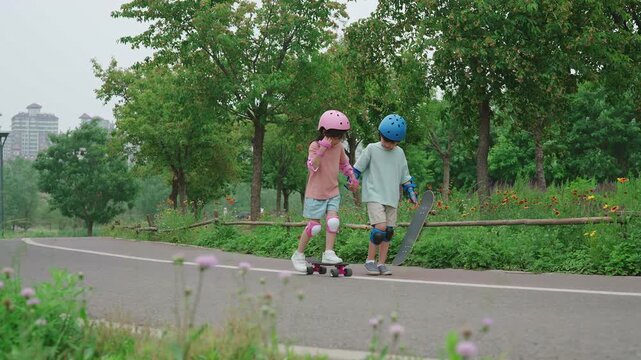 Happy kids skateboarding in the park