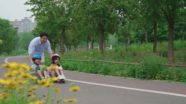 Dad taking kids skateboarding in the park