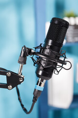Fototapeta na wymiar Professional black microphone for internet channel audio podcast live streaming. Mic equipment close up for sound and communication recording on radio in modern empty studio