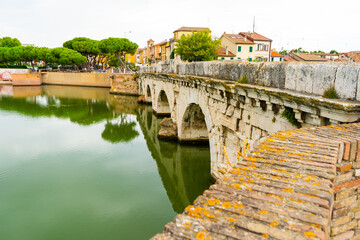 Fototapeta premium Tiberius Bridge over the river in Rimini. Italian classical architecture. A city landmark. Italy old city