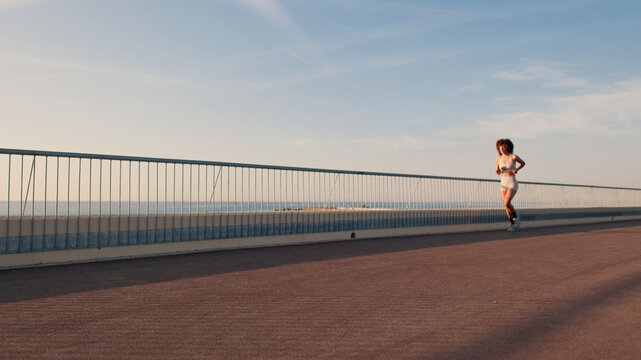 Runner on the bridge At Sunset