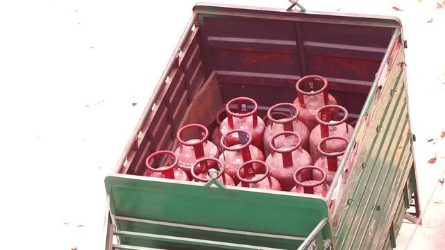 Dedicated laborers upload LPG cylinders to a truck  for efficient doorstep delivery, ensuring energy access in urban areas.