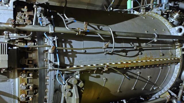 Detailed casing and fasteners closeup showing bolts, braided hoses, structural brackets and sensor cabling, aged metal textures, inspection points and measurement tags for integrity analysis