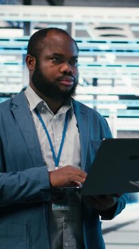 Vertical video Data center team of technicians uses AI deep learning on devices to optimize performance. Software developers brainstorm how to integrate neural network automation in data center