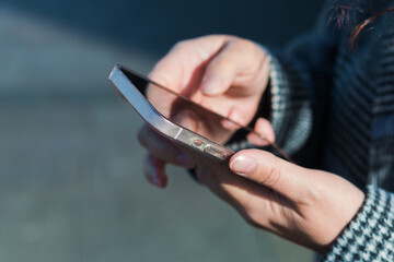 a woman using a mobile phone on the street