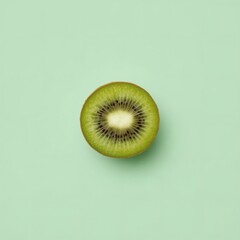 Half of fresh kiwi fruit on mint green background