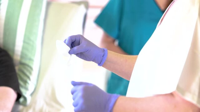 Nursing student learning wound care for leg ulcer under supervision, hands on training in clinical setting