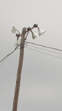 Sports field floodlights on wooden pole. vertical video