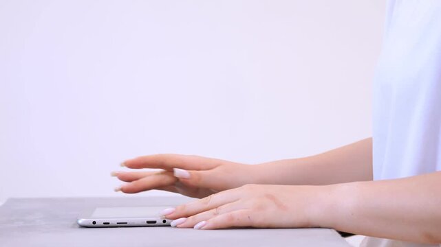 Hands rest gently on a sleek device. Fingers hover above, poised for action. Quiet focus, calm readiness, subtle gesture. Soft light, minimal background, clean surface. Implies connection, modernity