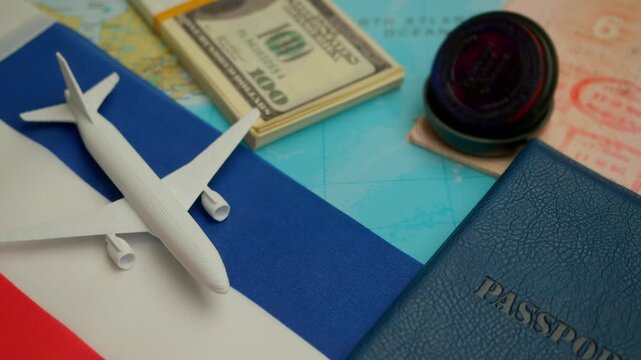 Airplane landing beside passport with visa stamp and dollar cash on world map with Yugoslavia flag, concept of historical travel and past international routes.