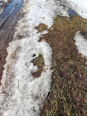 A road with mud and melting snow, spring off-road conditions.