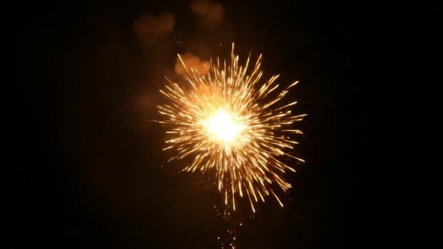 Extreme close-up of bright golden firework sparks exploding in dark