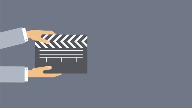 Hands holding a film clapperboard with chevron pattern