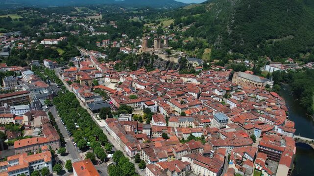 An aerial view around the old town in the city Foix on a sunny summer noon in France .