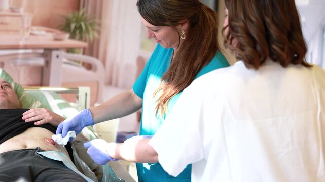 Stoma cleaning training on ostomy dummy demonstrating aseptic technique and peristomal care in nursing practice