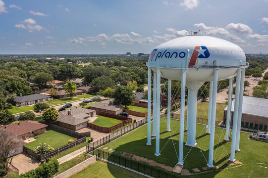 Aerial Drone View of Large White Water Tower Near Surrounding Neighborhood in Plano, Texas