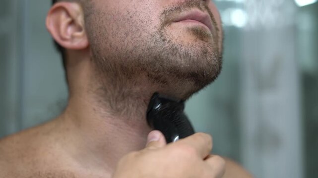 Man Trimming Beard on Neck with Electric Trimmer Close Up Grooming