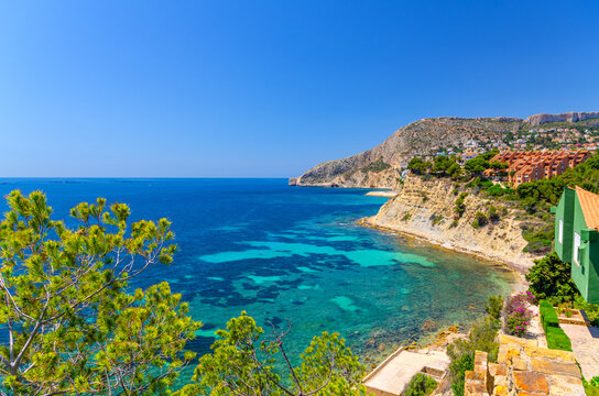 Aerial panoramic view Costa Blanca coast Calpe town, Sierra de Bernia mountain range, Calpe bay Mediterranean Sea with azure turquoise water in sunny summer day, Valencian Community, Spain