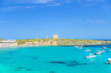Yachts and motor boats anchored in azure turquoise water of lagoon Alicante bay Mediterranean Sea near coast Tabarca Island Nueva Tabarca Isla Plana, Fort Fuerte building in sunny summer day, Spain
