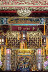 Intricate woodcarvings, bathed in resplendent gold leaf, transform the altar into celestial stage. Within this shimmering realm, the Five Royal Lords are enshrined amidst a tapestry of traditional mot