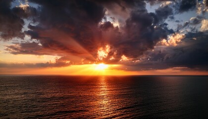 Fototapeta premium Red Sunset Over The Sea Rich In Dark Clouds Rays Of Light