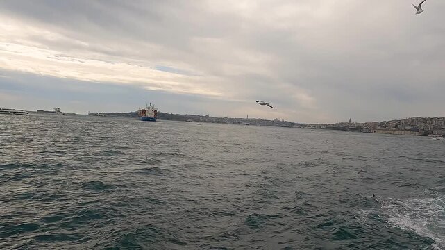 Cargo Ship Passing Through Bosphorus Strait. Bulk Carrier Ship, Bosphorus Strait, Turkey. Sea freight transportation concept. Transport logistics.