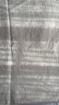 sunlight and window shadows on white linen bed sheets