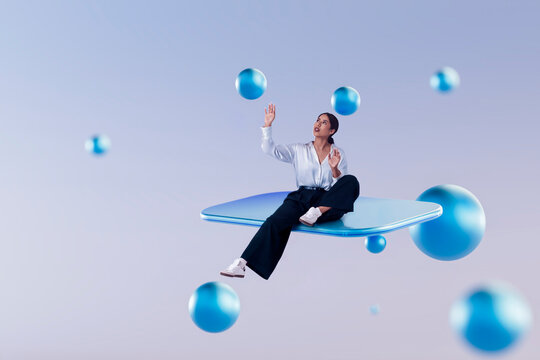 Latin woman sitting on floating 3D platform reaching toward blue spheres in abstract digital space
