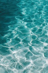 Fototapeta premium Deep teal water sunlight ripples shimmering reflections vertical closeup of clear coastal sea pattern and luminous surface texture