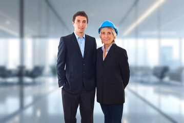 Fototapeta premium Two professionals stand side by side in a modern office space