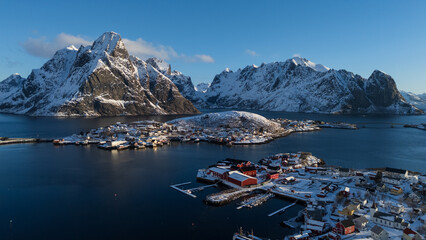 Aerial view of snowy fishing village and fjord with dramatic mountains in Lofoten Islands, Norway © Andrei Tomas