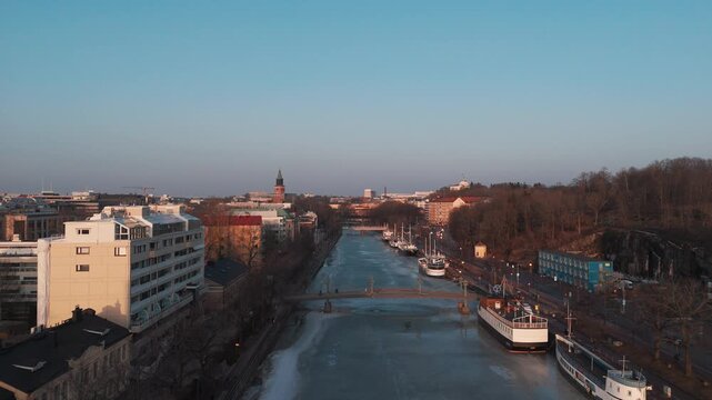 Aerial panorama of Turku city and frozen Aura River at spring sunset