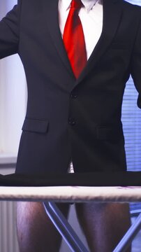 Headless Businessman with red tie iron black pants while wearing boxers 
