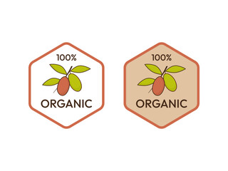 Set of two organic product emblems with a green olive branch illustration in a hexagon frame.