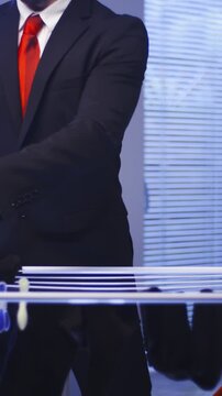 Headless Businessman with red tie hand washed clothes doing housework