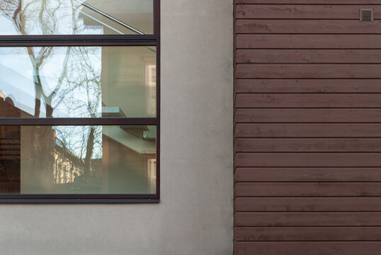 Modern house facade with window and interior staircase