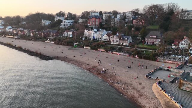 Hamburg Germany 2026 03 09: Aerial drone footage of the beach at the Elbe River in Hamburg &Ouml;velg&ouml;nne during beautiful sunset