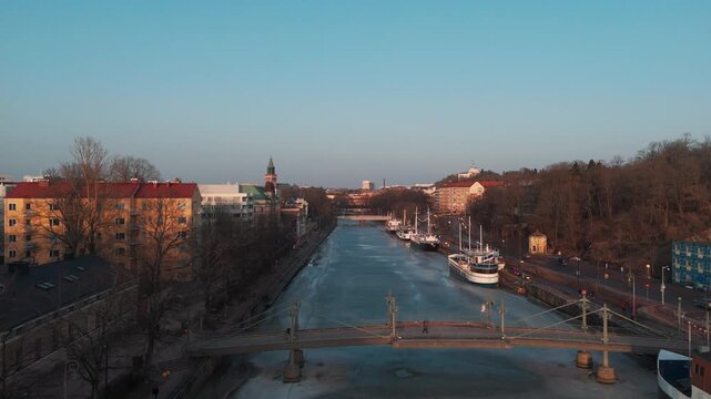 Aerial panorama of Turku city and frozen Aura River at spring sunset