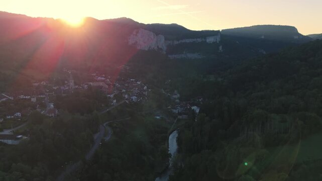 Aerial drone footage of ascent over the village Mouthier-Haute-Pierre in the French Jura near Lods in France at sunrise