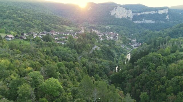 Aerial drone footage of flight towards the village Mouthier-Haute-Pierre in the French Jura near Lods in France at sunrise