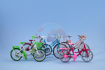 Fototapeta premium World Bicycle day. Bicycles in front of globe representing global sustainable transport