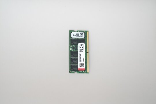 DDR5 ECC RAM Memory Module by SK hynix on White Background. Close-up of a green DDR5 ECC RAM memory module with gold contacts and labels, isolated on white background for AI and data centers