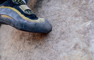 Precise climbing shoe edge on a tiny rock foothold with copy space © RTEKA