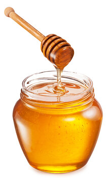 Honey dripping from honey stick into honey pot on a white background. File contains clipping path.