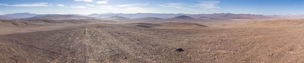 Panoramic view of Vaca Muerta strewnfield in Atacama Desert, Chile. Vast arid landscape with rocky...