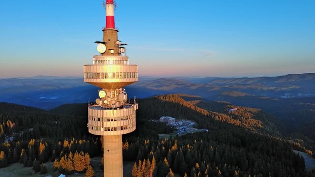 Tower Snezhana on peak of Snezhana covered with spruce forests in Rhodope mountains